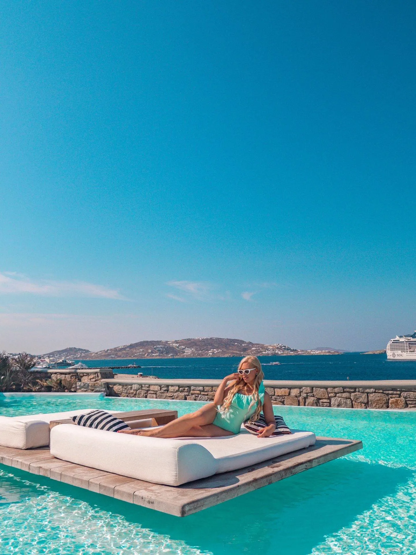 Lounging at Cavo Tagoo, one of the most instagrammable places in Mykonos. Click the photo to see the rest of my list of the most instagrammable places in Mykonos! 