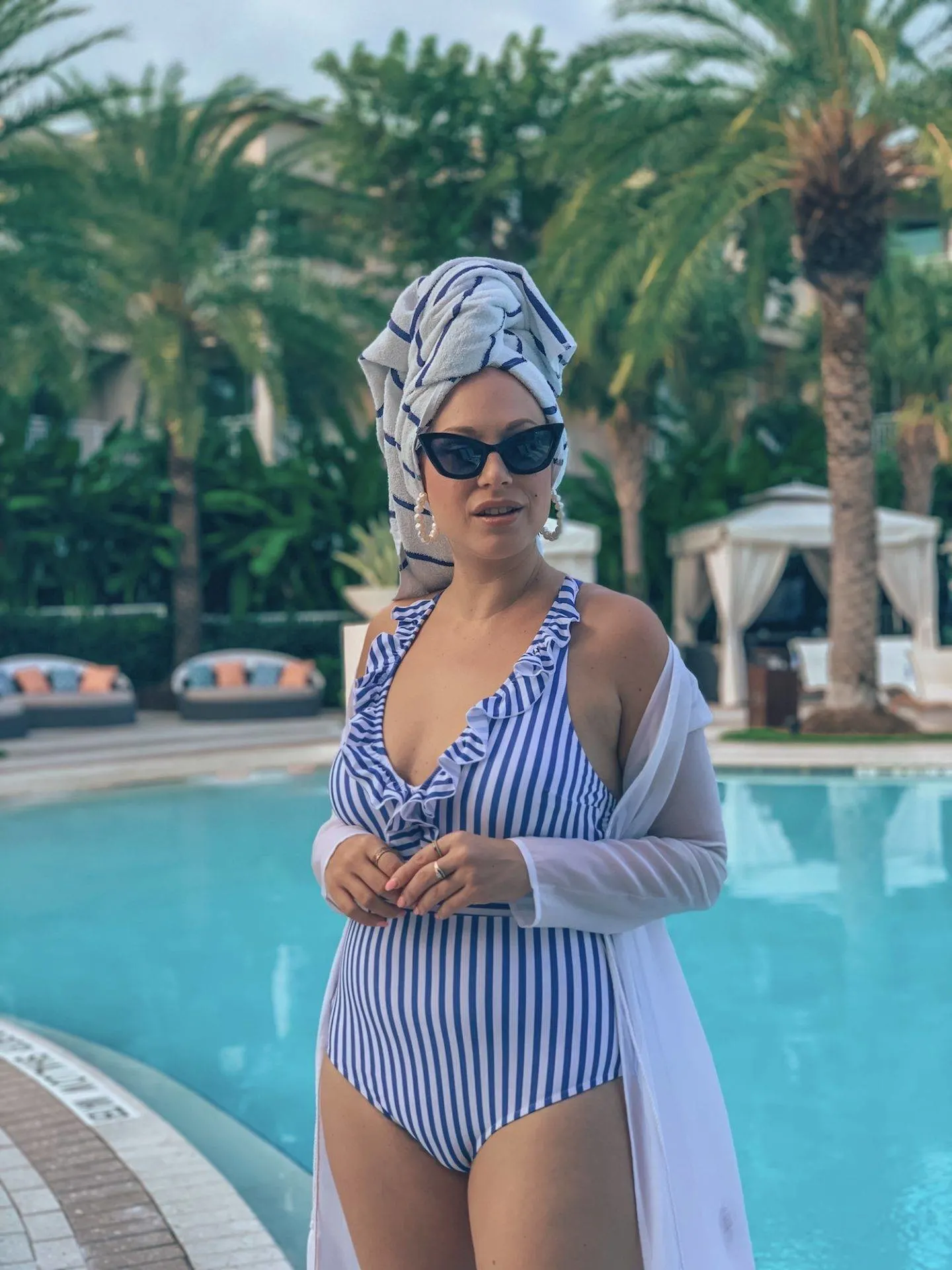 The perfect flattering swimsuit with stripes and ruffles by Cupshe. Seen here poolside in Key Largo
