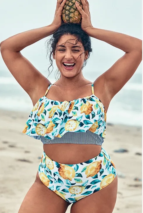 Lemon print Cupshe plus-sized swimsuit worn on smiling girl on the beach