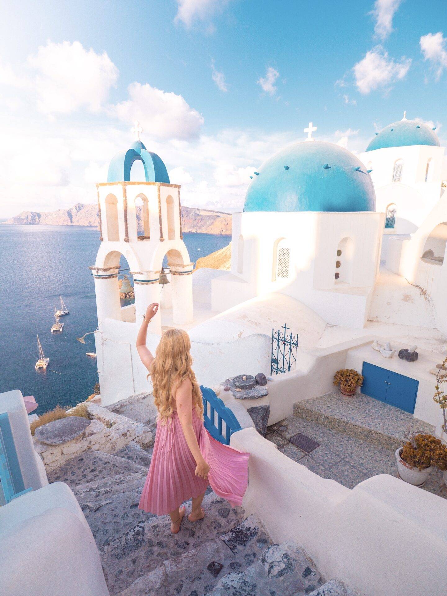 The best photo spots and most instagrammable places in Santorini: Blue Domes of Oia. Click the photo to see the rest of my list of the best instagram photo spots in Santorini!