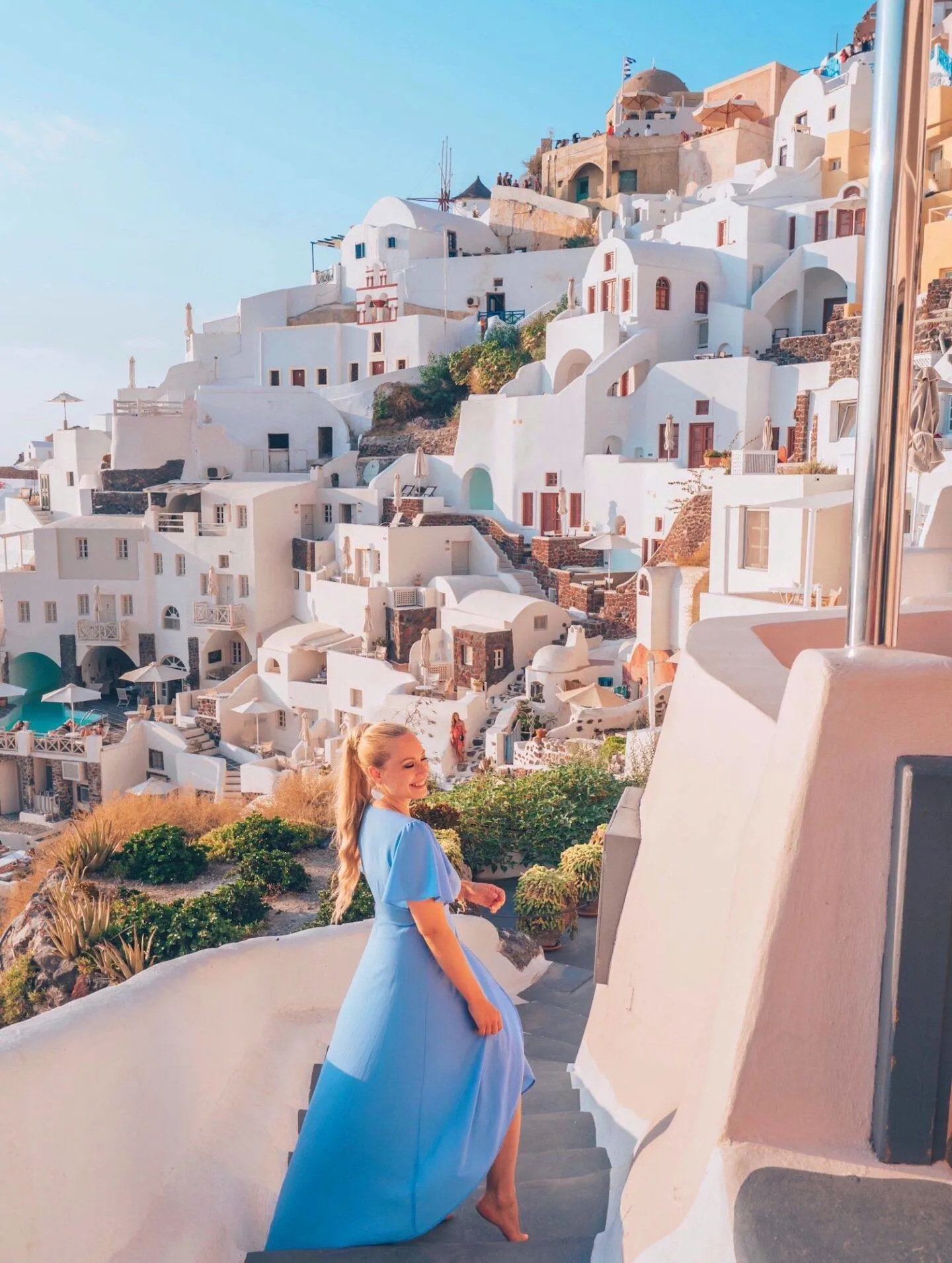 The best photo spots and most instagrammable places in Santorini: Oia Cliffside. Click the photo to see the rest of my list of the best instagram photo spots in Santorini!