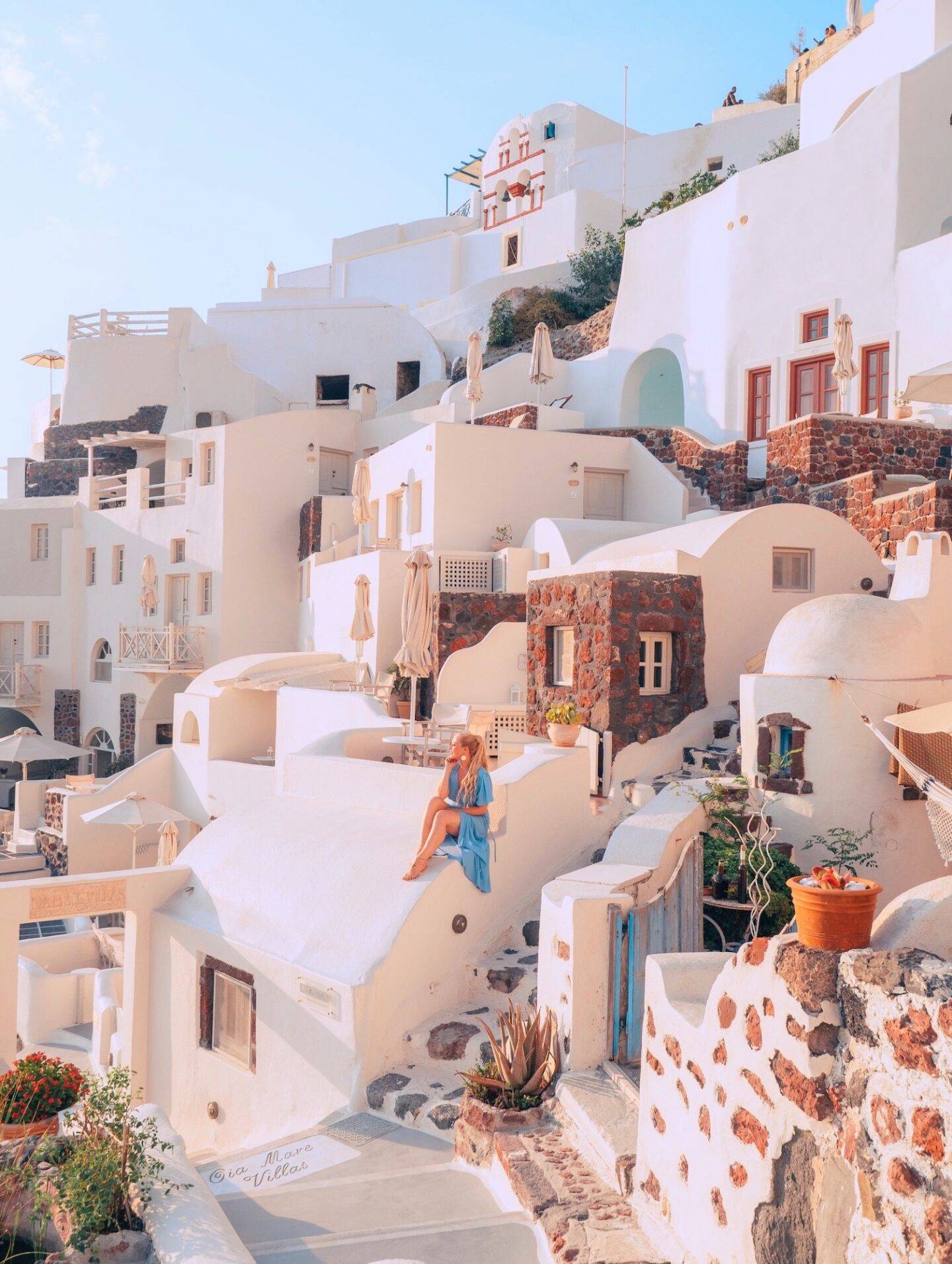 The best photo spots and most instagrammable places in Santorini: Oia Cliffside. Click the photo to see the rest of my list of the best instagram photo spots in Santorini!