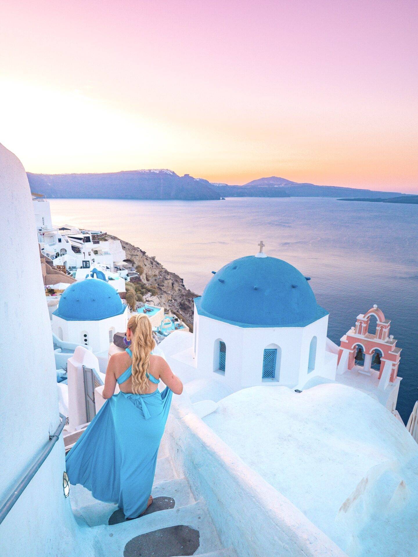 The best photo spots and most instagrammable places in Santorini: The famous blue domes of Oia. Click the photo to see the rest of my list of the best instagram photo spots in Santorini!