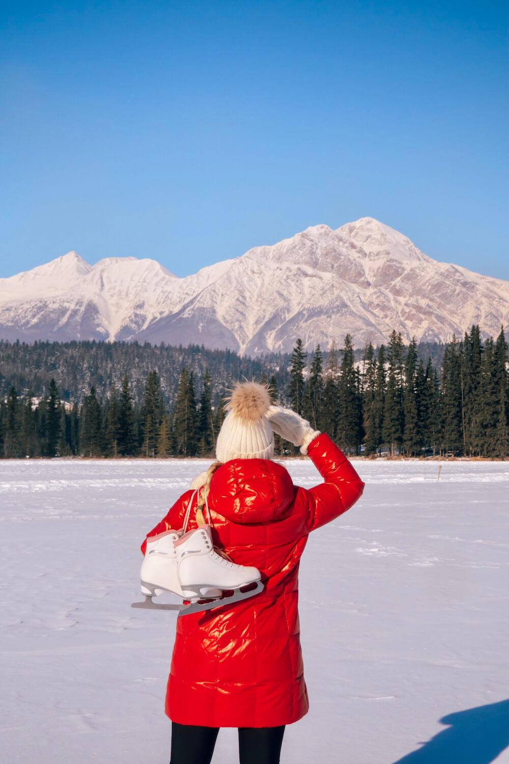 Although most people visit Banff when the weather is warmer, it's absolutely magical to visit in winter. Here's a local's guide to some of the best things to do in in Banff in winter. From hikes and trails to winter sports, family friendly excursions, dining experiences and more. You won't want to miss this guide that will surely convince you to add Banff to your winter travel bucket list. Pictured here: Go skating on a frozen lake surrounded by mountains