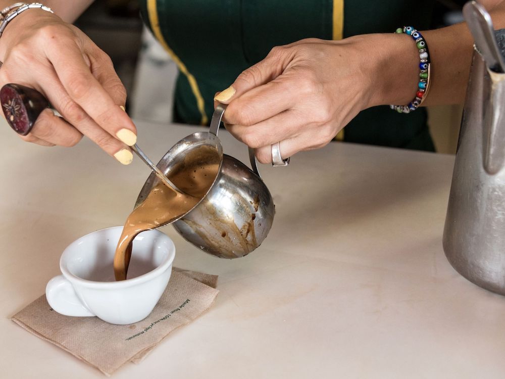 How to spend 1 perfect day in Little Havana, Miami. A complete guide on what to see and do, which restaurants to dine at, bars to visit, Cuban treats to try and more. If you're headed to Little Havana for the day you'll definitely want to read this guide! Pictured here: Cuban coffee