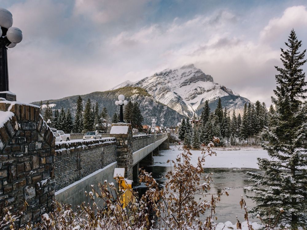 Although most people visit Banff when the weather is warmer, it's absolutely magical to visit in winter. Here's a local's guide to some of the best things to do in in Banff in winter. From hikes and trails to winter sports, family friendly excursions, dining experiences and more. You won't want to miss this guide that will surely convince you to add Banff to your winter travel bucket list. Pictured here: Downtown Banff
