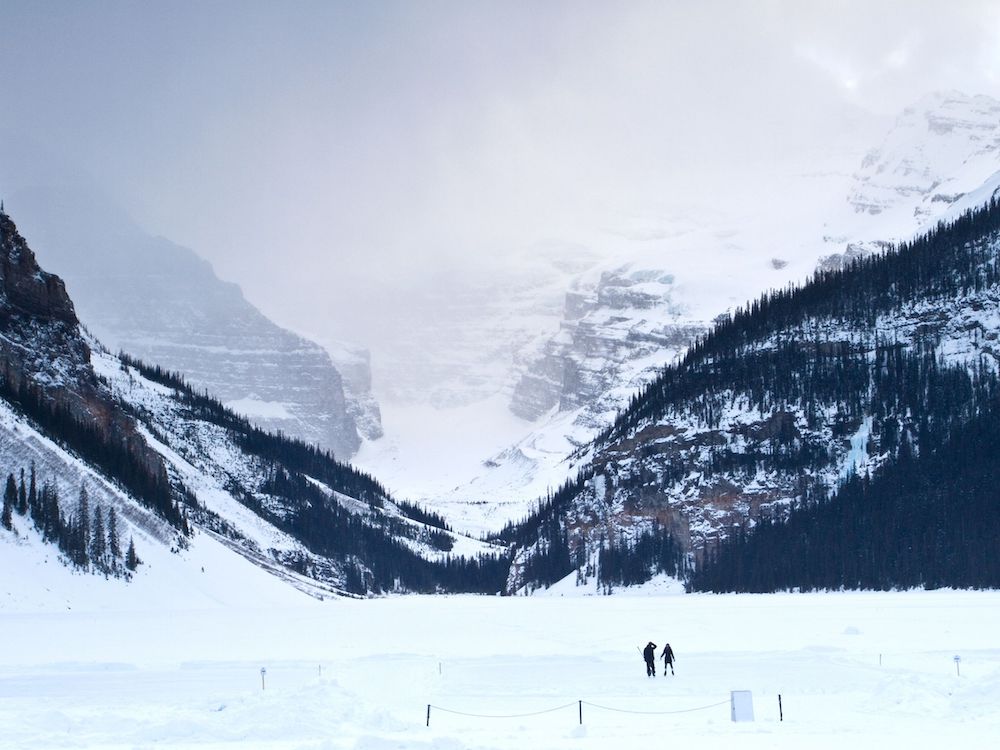 Although most people visit Banff when the weather is warmer, it's absolutely magical to visit in winter. Here's a local's guide to some of the best things to do in in Banff in winter. From hikes and trails to winter sports, family friendly excursions, dining experiences and more. You won't want to miss this guide that will surely convince you to add Banff to your winter travel bucket list. Pictured here: Go skating at Lake Louise
