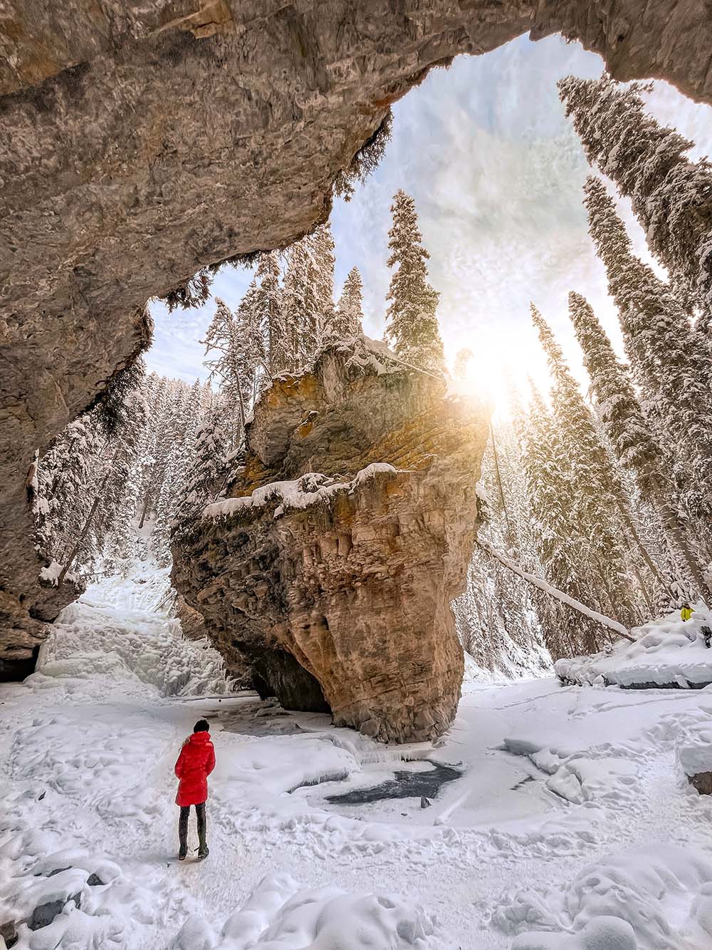 Experiencing the wonders of the Johnston Canyon ice walk is something you absolutely have to do when visiting Banff during the winter months. This guide has everything you need to know before hiking Johnston Canyon in winter. It includes tips on everything from how to prepare, what to wear, special equipment you'll need, how to find the secret cave and more! Pictured here: the Secret Cave