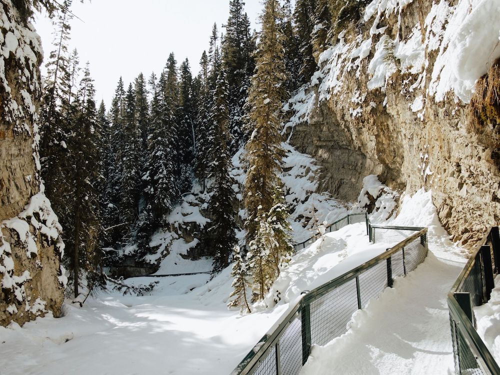Experiencing the wonders of the Johnston Canyon ice walk is something you absolutely have to do when visiting Banff during the winter months. This guide has everything you need to know before hiking Johnston Canyon in winter. It includes tips on everything from how to prepare, what to wear, special equipment you'll need, how to find the secret cave and more! Pictured here: Johnston Canyon