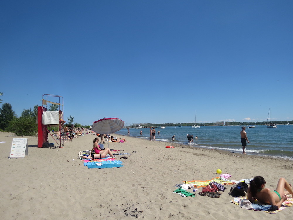 Looking for a great beach to spend a hot summer day laying in the sun on? This guide to the best beaches in Toronto is for you! Whether you're looking for a relaxing and quiet beach hang, the perfect beach for a family picnic, or want to enjoy the beach life in a more lively environment, there is Toronto beach for you. Pictured here: Ward's Island Beach