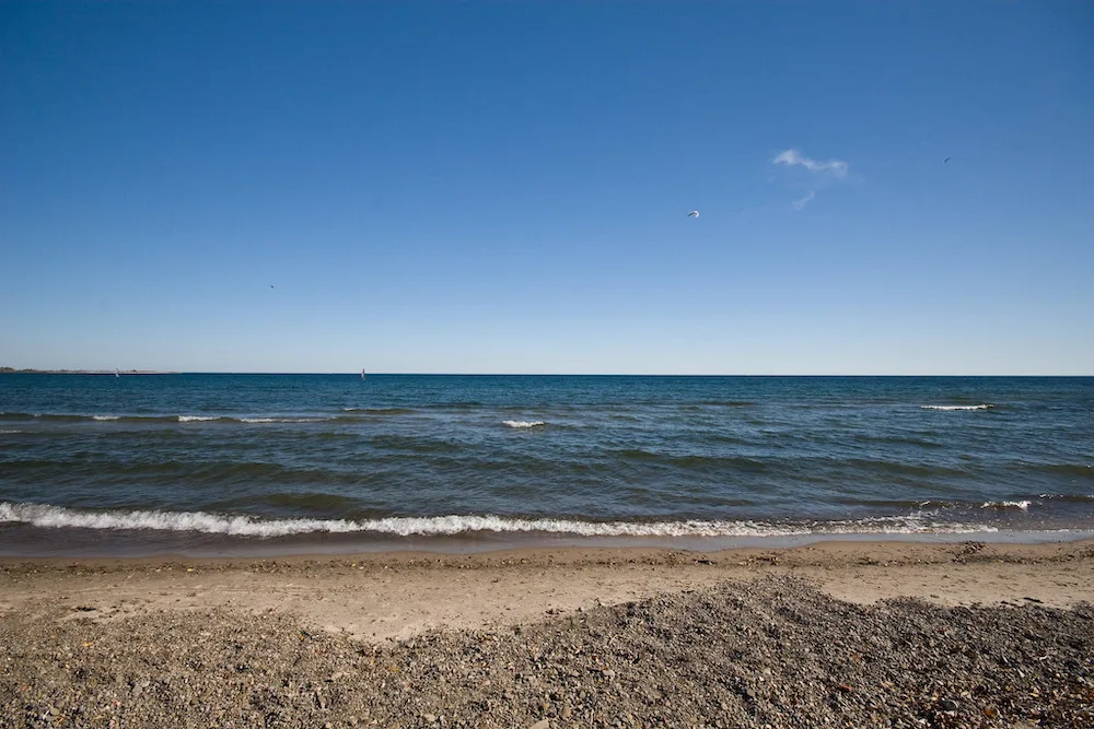 Looking for a great beach to spend a hot summer day laying in the sun on? This guide to the best beaches in Toronto is for you! Whether you're looking for a relaxing and quiet beach hang, the perfect beach for a family picnic, or want to enjoy the beach life in a more lively environment, there is Toronto beach for you. Pictured here: Marie Curtis Park East Beach