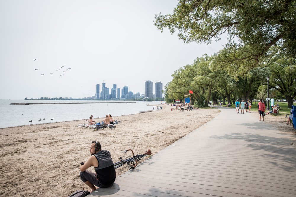 Looking for a great beach to spend a hot summer day laying in the sun on? This guide to the best beaches in Toronto is for you! Whether you're looking for a relaxing and quiet beach hang, the perfect beach for a family picnic, or want to enjoy the beach life in a more lively environment, there is Toronto beach for you. Pictured here: Sunnyside Beach