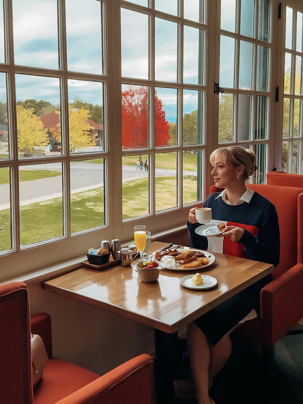 Cozy breakfast at the Algonquin Resort with eggs Benedict, coffee, and natural light streaming through the dining room windows.
