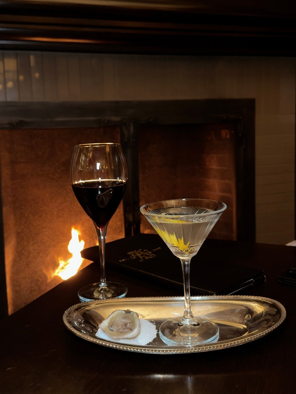 Signature martini served with an oyster at the Algonquin Resort restaurant, celebrating East Coast cuisine and local flavours.
