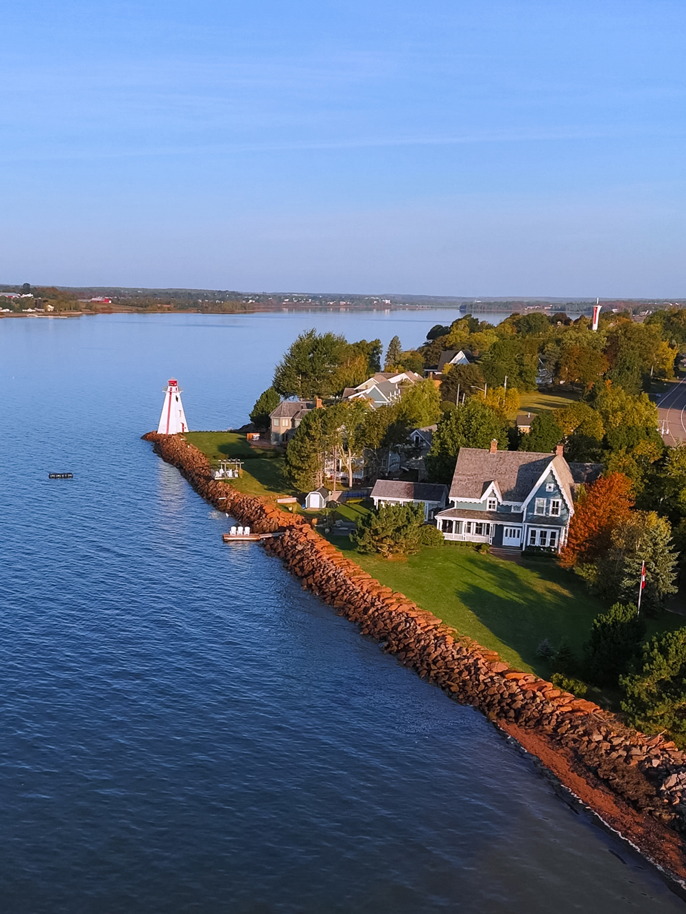 Lighthouse and heritage homes along the Charlottetown waterfront &mdash; scenic fall views by the harbor.