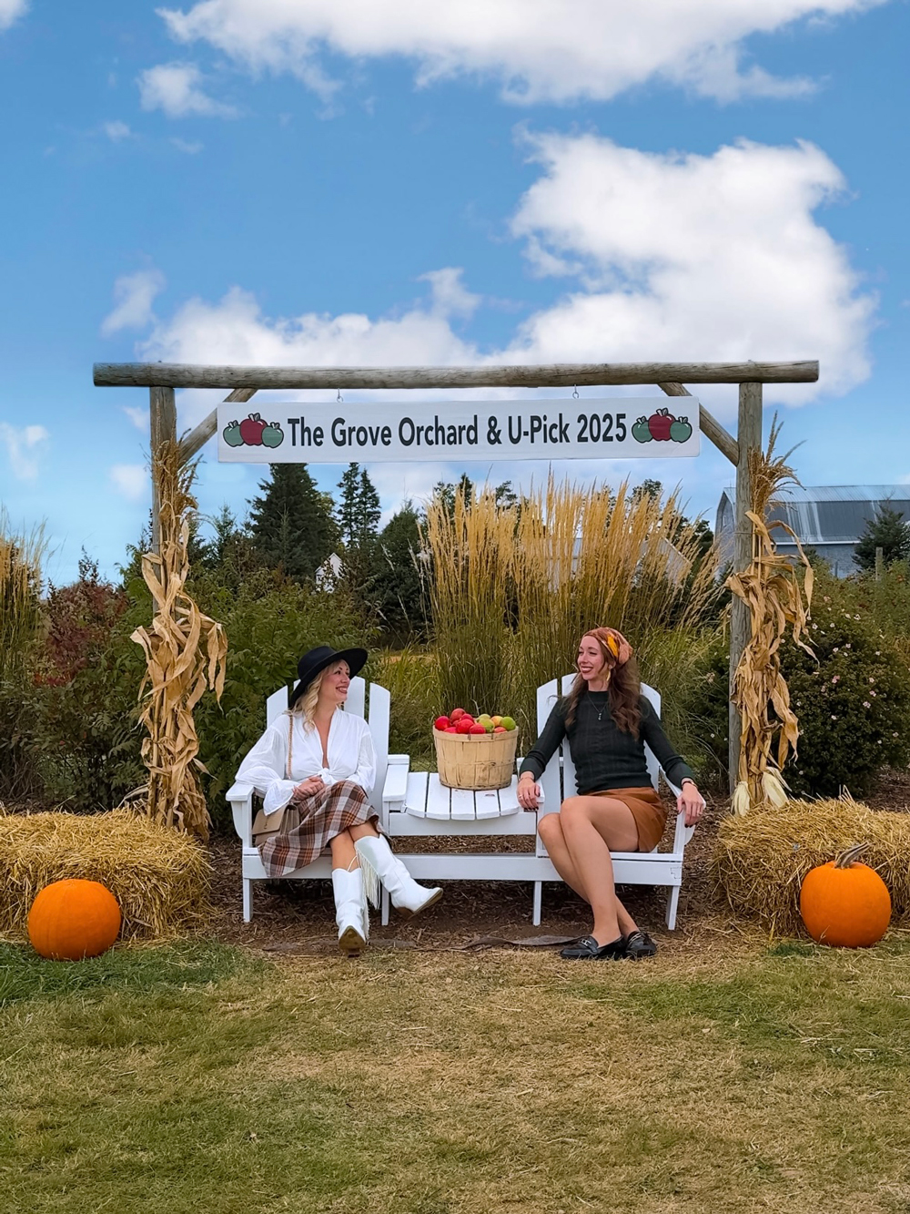 Friends enjoying a fall day at The Grove Orchard near Charlottetown, PEI &mdash; apple picking, pumpkins, and cozy seasonal vibes.