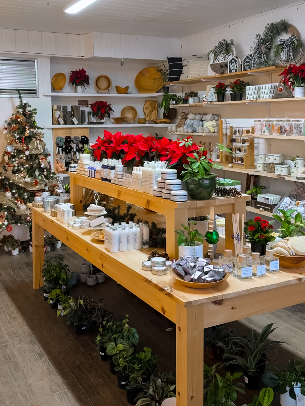 Cozy Montebello boutique decorated for Christmas with poinsettias, holiday displays, handcrafted goods, and locally made gifts.
